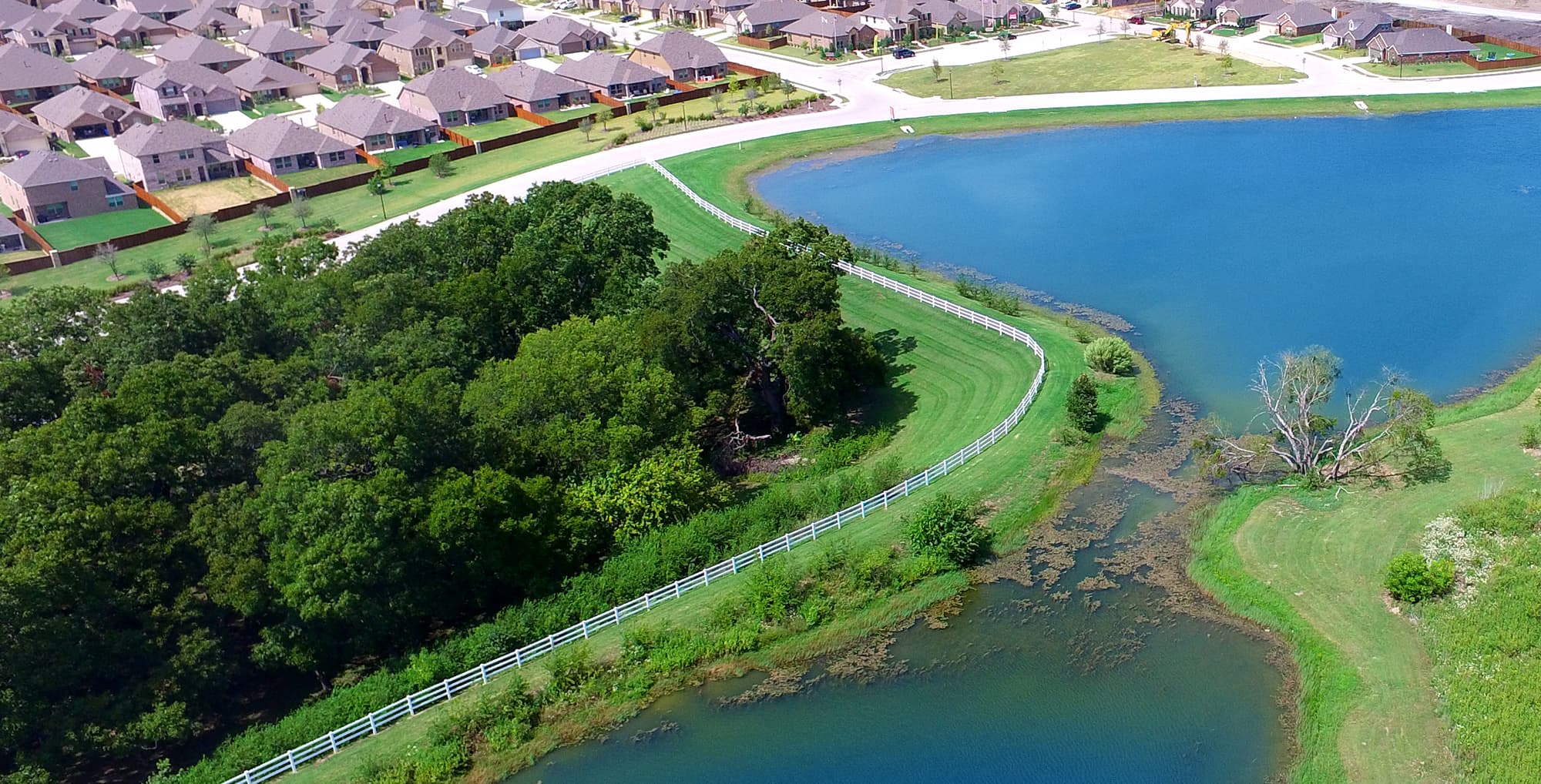 Aerial view of a lake and greenbelt